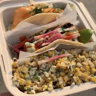 Pork taco and fish taco with a side of street corn