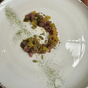 Lamb Tenderloin &quot;Au Sauvage&quot;. Roasted Pistachio, Green Tomato. Grilled Onion. Green Charmoula. With my fingerprint.