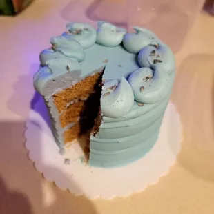 a half eaten cake with blue frosting