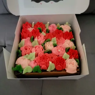 a box of decorated cupcakes