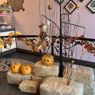 a display of pumpkins and hay bales