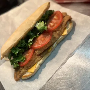 a sandwich with tomatoes and lettuce