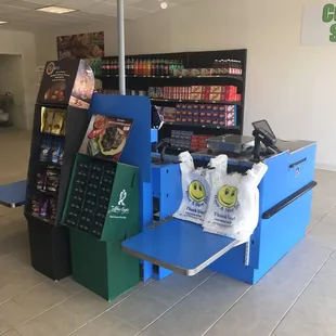 a cash register and a grocery counter