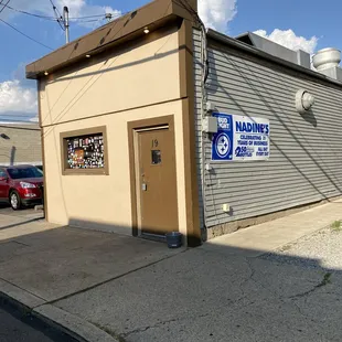 a building with a sign that says nadine's