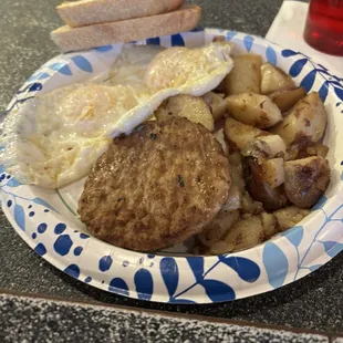 Two eggs over medium with sausage and home fries