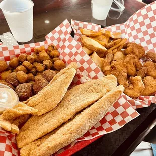 a basket of fried fish and fries