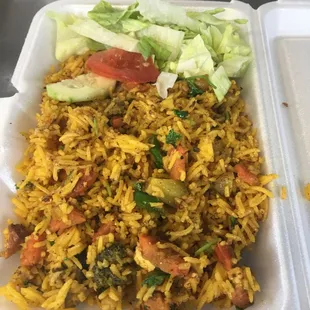 a takeout container with a salad and rice dish