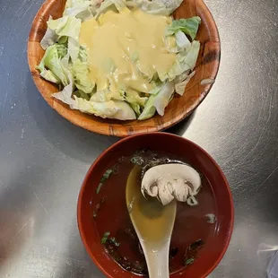 a bowl of soup and a bowl of salad