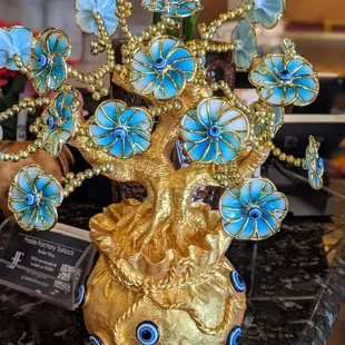 a gold vase with blue flowers