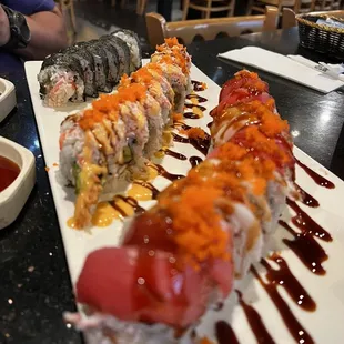 a plate of sushi and sauces