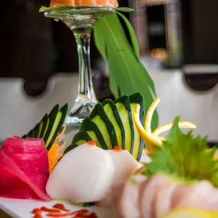 a plate of sushi and vegetables