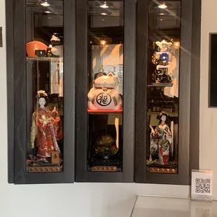 a display case with asian figurines