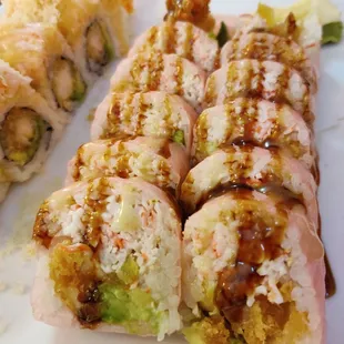 a plate of sushi and rolls