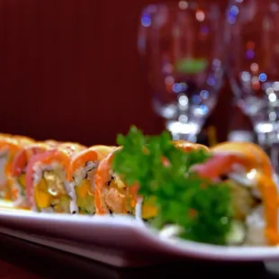 a plate of sushi and wine glasses