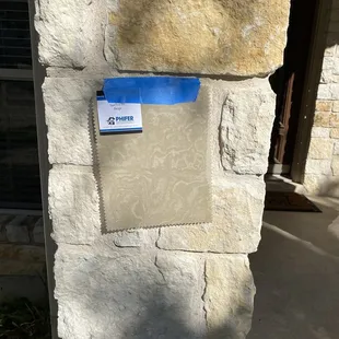 a sign on a stone wall