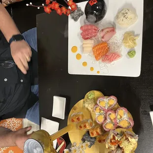 Sashimi Deluxe on top. The bottom is Christmas roll, out of control roll, spicy girls roll, sweet heart roll.