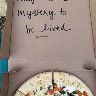 Margarita pizza with an inspirational pizza box