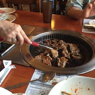 Owner making the delicious BBQ at our table