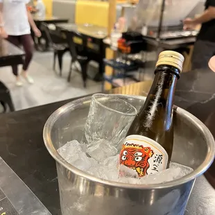 a bottle of beer in a bucket