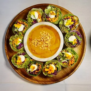 a plate of lettuce wraps and a bowl of soup