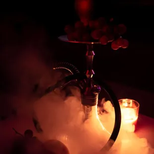 a hook and a glass of water with a candle in the background