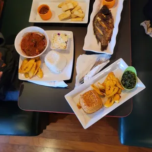 Peppered Goat, white rice,plantains coleslaw, yam fries,grilled fish,jollof rice,and spinach