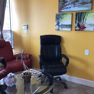 Waiting area. Red couch reclines.