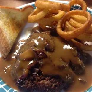 Hamburger Steak Dinner with onion rings and bread