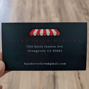 a hand holding a business card