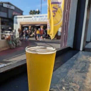a glass of beer on a window sill