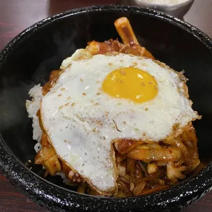 a fried egg on top of noodles