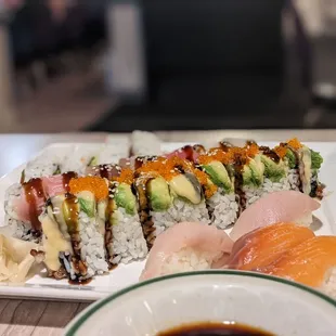 a plate of sushi and a bowl of sauce