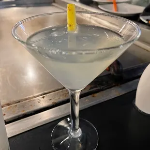 a martini in a martini glass with a lemon garnish