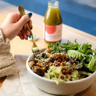 a woman eating a salad with a fork