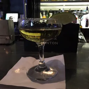 a glass of wine with a lime wedge