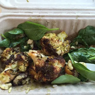 Yummy cauliflower steak over brown rice, cherry tomatoes, mushrooms, and fresh spinach with chimichurri dressing. I added cashews. Amazing!!