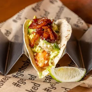 a taco with a lime wedge