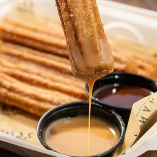 a churron being drizzled with melted chocolate