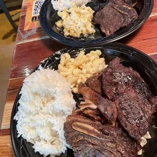 two plates of meat and rice