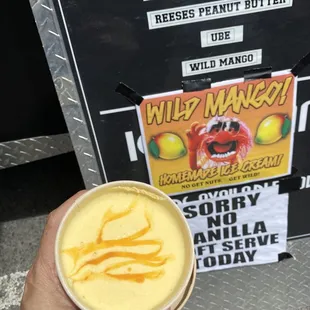 a hand holding a cup of a drink