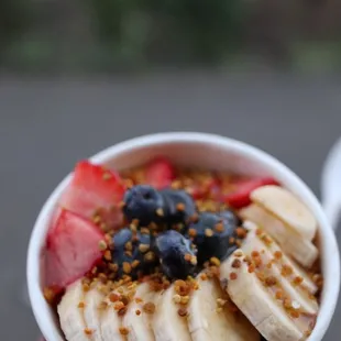 a person holding a bowl of fruit