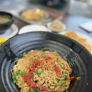 a plate of noodles with meat and vegetables
