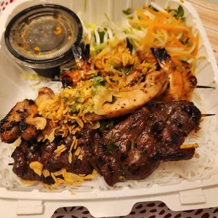 grilled meat and vegetables in a styrofoam container