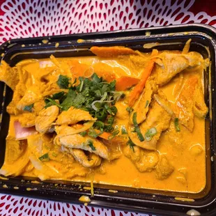 chicken curry in a black container