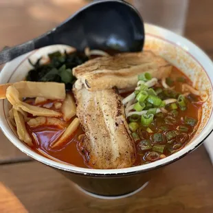 a bowl of soup with tofu and vegetables