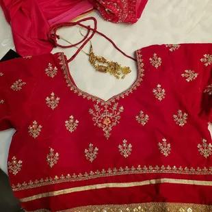 a red blouse with gold work