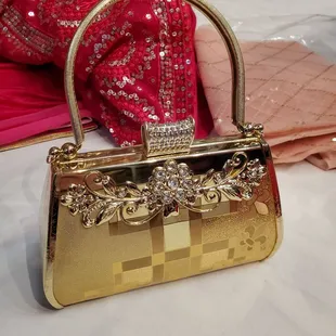 a gold purse with a diamond clasp