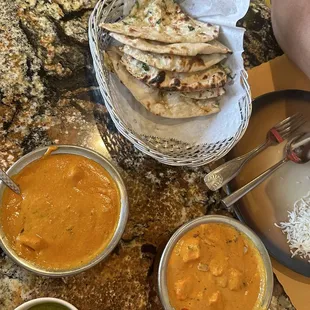 Butter Chicken left. Chicken Tikka Masala right. Garlic naan.