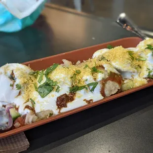 Dahi puri - yogurt tamarind sauce. Delish. Sweet, a little tart, and refreshing