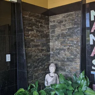 a buddha statue in front of a sign that says namaste